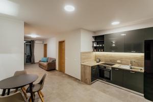 a kitchen with a table and a dining room at Boka Apartment 4 in Herceg-Novi