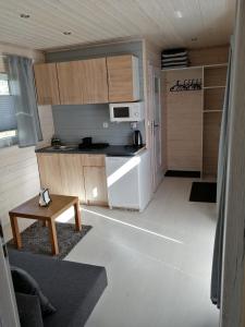 a small kitchen with a white refrigerator and a table at Apartament Antonio 1 Gdańsk in Gdańsk