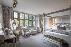a bedroom with a bed and a desk in a room at Cragwood Country House Hotel in Windermere
