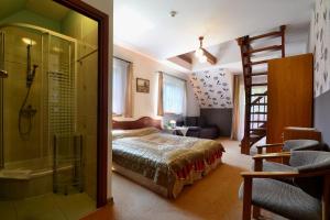 a bedroom with a bed and a glass shower at Willa Zarębek in Łopuszna +43 photos