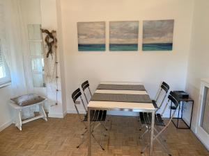 a dining room with a table and chairs at Ocean in Bordighera