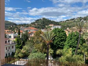 a view of a city with palm trees and houses at Ocean in Bordighera