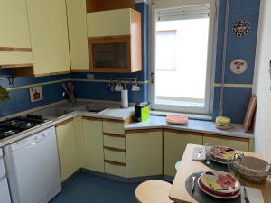 a kitchen with yellow and blue walls and a table at Ocean in Bordighera