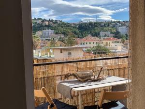 a balcony with a table and a view of a city at Ocean in Bordighera +8 photos
