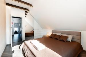 a bedroom with a large bed and a staircase at Stylish, modern apartment near Vilnius Old Town in Vilnius