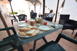 a table with a plate of bread and toast at Alba Tra I Pini B&B in Cefalù