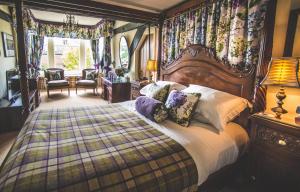 a bedroom with a large bed with pillows at Jeakes House in Rye