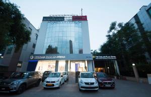 a group of cars parked in front of a building at The Oakland Plaza by Orion Hotels in New Delhi