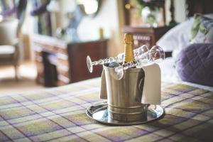 a bottle of champagne in a cup on a table at Jeakes House in Rye