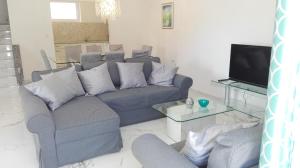 a living room with a couch and a tv at Apartmani Mirta in Dramalj