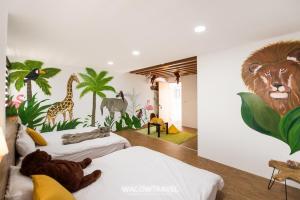 a room with two beds and a mural of a lion and giraffe at Twenty Eight B&B in Xiaoliuqiu