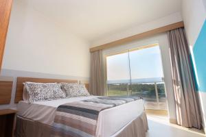 Cama ou camas em um quarto em Ilhas do Lago Eco Resort by WAM Experience