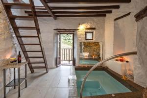 a bathroom with a swimming pool and a staircase next to a bath tub at Fimaira 2 in Ermoupoli