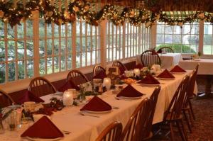a room with long tables with red napkins and candles at Red Rocker Inn in Black Mountain +153 photos