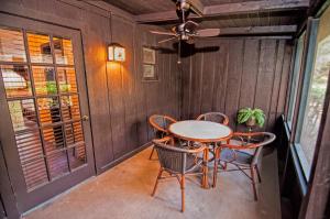 a patio with a table and chairs and a ceiling fan at Westgate River Ranch Resort & Rodeo in River Ranch