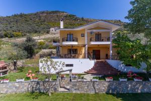 a house on the side of a hill at Villa Loridis in Prinos