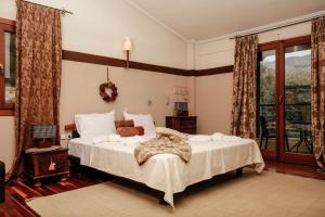 a bedroom with a large bed and a window at Villa Loridis in Prinos +55 photos