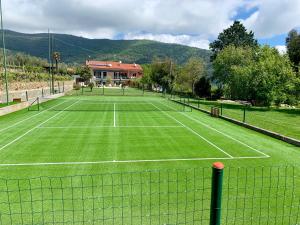 a tennis court with two people on it at Agriturismo Ada Musso in Diano Borello