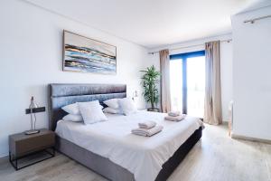 a bedroom with a large bed with towels on it at VILLA BONANOVA by Priority in Palma de Mallorca