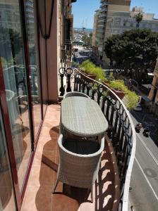 a wooden bench sitting in front of a building at Apartamentos Boni in Alicante