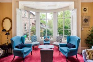 a room with chairs and a table and a large window at Astor York Hostel in York