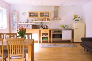 a kitchen and living room with a table and a refrigerator at Eifel Relax in Hillesheim