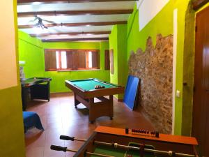 a room with a pool table and a stone wall at Casa rural el turmell in Xert