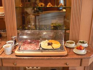 a buffet with a tray of food on a table at Hôtel Le Mittelwihr in Mittelwihr +36 photos