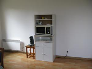 a microwave sitting on a shelf in a room at pasteur in Cholet