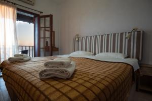 a hotel room with a bed with towels on it at Villa Kalliopi in Gerakini