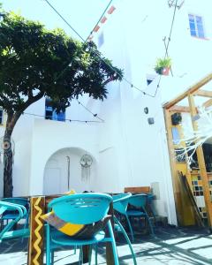 a group of tables and chairs in front of a building at Casa do Pátio- Bed & Breakfast- City Center in Portalegre