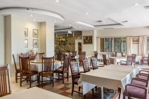 a dining room with tables and chairs in a restaurant at Ayothaya Riverside Hotel in Phra Nakhon Si Ayutthaya