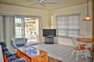 a living room with a couch and a tv and a table at Fort Lauderdale Yacht and Beach Club 416 in Fort Lauderdale