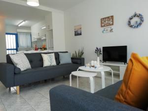 a living room with a couch and a table at Ocean Blue Apartments in Paphos