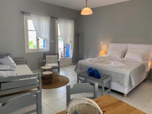 a bedroom with a bed and a living room at Kiki Studios in Fiskardo