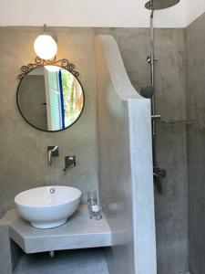a bathroom with a sink and a mirror at Kiki Studios in Fiskardo