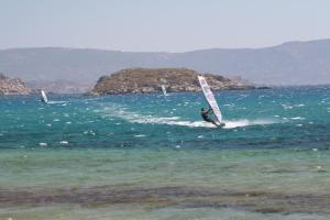 two people windsurfing in the ocean on the water at Roses Studios in Karpathos