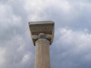 a stone pole with a sky in the background at Roses Studios in Karpathos