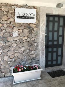 a door to a building with a stone wall at Bed & Breakfast La Rocca in Taormina
