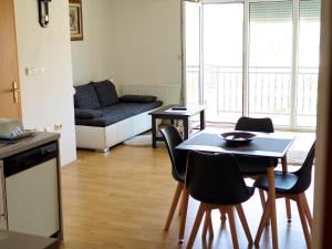 a kitchen and living room with a table and chairs at Apartment Ivan-Experience 3 Bedrooms in Ljubuški