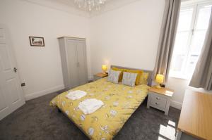 a bedroom with a bed with towels on it at Grade 2 Listed Apartment, Southport Promenade in Southport