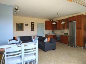 a living room with a couch and a kitchen at Beautiful house by the sea,Loutraki Skaloma. in Loutraki +33 photos