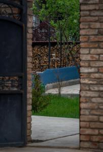 a brick building with a door and a window with a view of a park at Rivendell in Borjomi