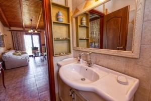 a bathroom with a sink and a mirror at Villa Ergina in Agios Nikolaos