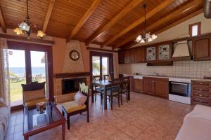 a kitchen with a table and a dining room at Villa Ergina in Agios Nikolaos +21 photos