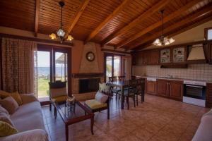 a kitchen and living room with a couch and a table at Villa Ergina in Agios Nikolaos