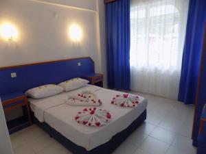 Postel nebo postele na pokoji v ubytování Dilhan Hotel