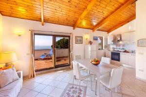 a living room with a table and a kitchen with a view at Appartamento Villa degli Ulivi in Sant'Agnello