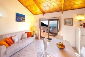 a living room with a couch and a table at Appartamento Villa degli Ulivi in Sant'Agnello