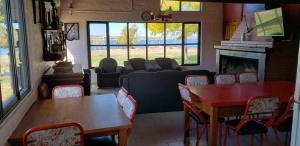 a living room with a couch and a table and chairs at Casa Vistalago - El Nihuil in El Nihuil